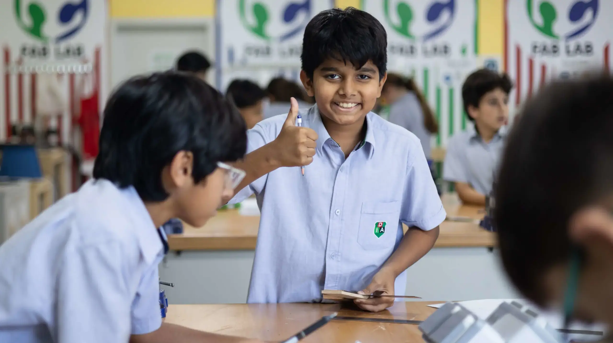 DIA AB student smiling and giving thumbs up